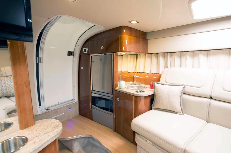 Opty Mystic Yacht Photos Pics Interior of a 2018 Formula 310 Sun Sport boat with kitchenette and seating area.