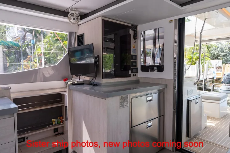 Just Lion Around Yacht Photos Pics Interior of 2020 Leopard 45 yacht with modern kitchen and outdoor view.