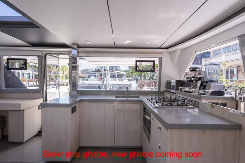 Just Lion Around Yacht Photos Pics Modern kitchen interior of 2020 Leopard 45 yacht with appliances and large windows.