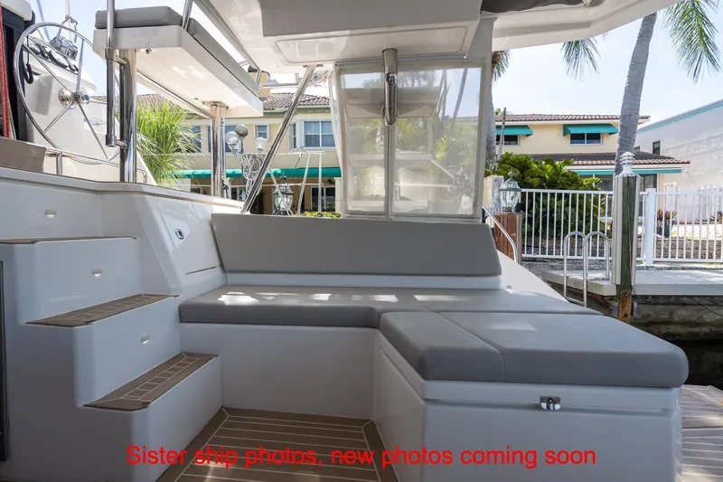 Just Lion Around Yacht Photos Pics Leopard 45 yacht interior with seating area, docked near waterfront homes.