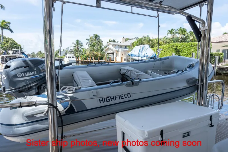 Just Lion Around Yacht Photos Pics Leopard 45 yacht with Highfield tender and Yamaha engine, docked in a scenic marina.