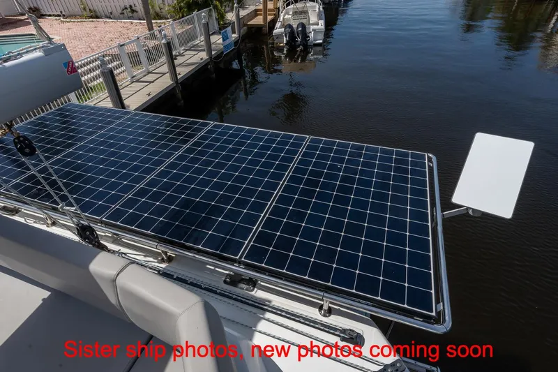 Just Lion Around Yacht Photos Pics 2020 Leopard 45 catamaran with solar panels docked by the water.