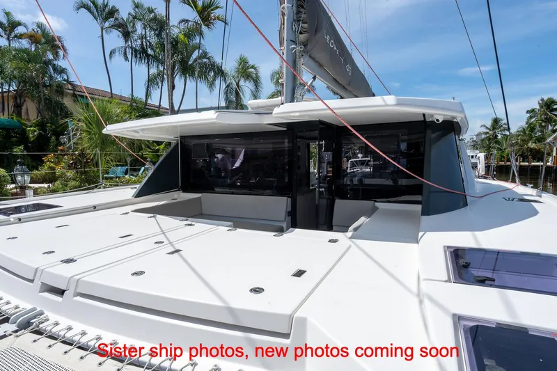 Just Lion Around Yacht Photos Pics 2020 Leopard 45 catamaran docked, featuring spacious deck and modern design.