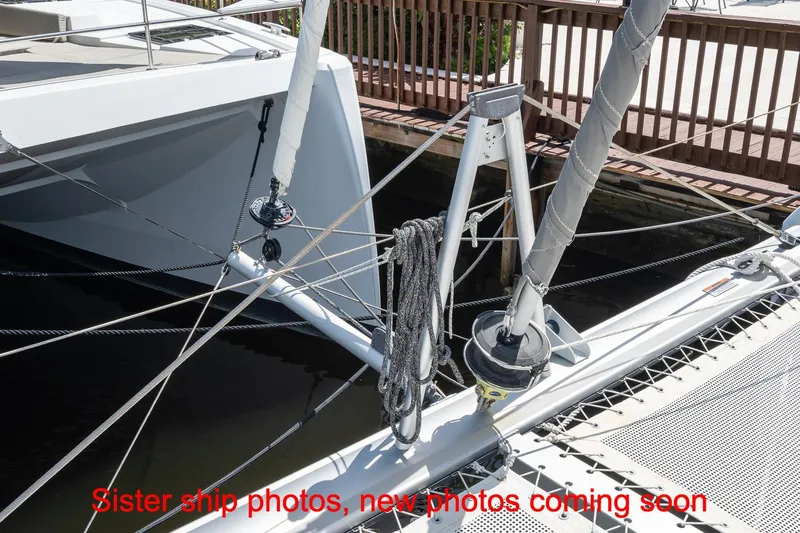 Just Lion Around Yacht Photos Pics 2020 Leopard 45 catamaran deck with rigging and netting, docked at marina.