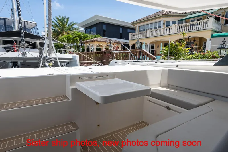 Just Lion Around Yacht Photos Pics Leopard 45 catamaran deck with seating, docked near luxury waterfront homes.