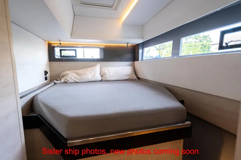 Just Lion Around Yacht Photos Pics Modern cabin interior of 2020 Leopard 45 yacht with cozy bed and windows.
