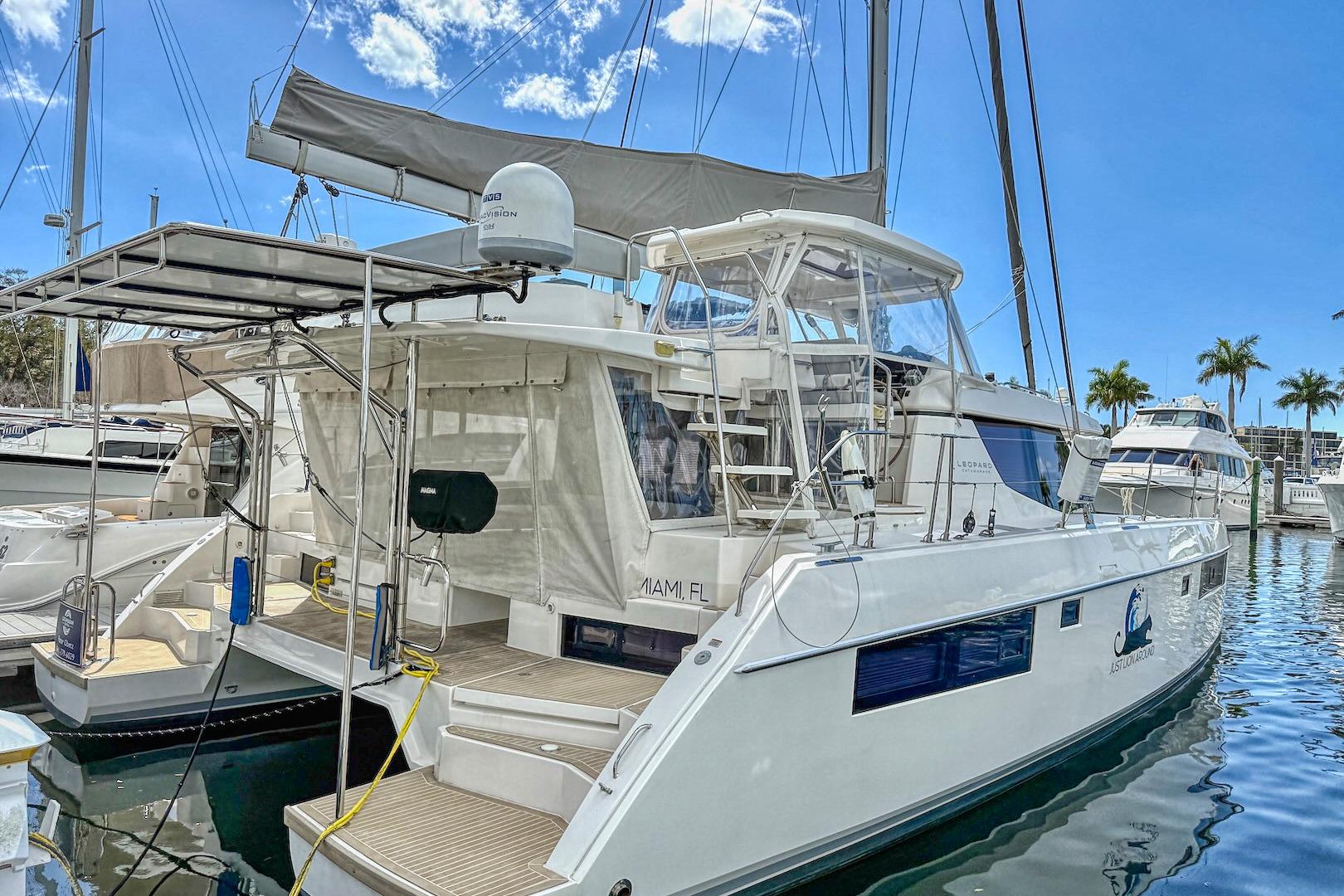 Luxury Leopard 45 catamaran docked in marina, 2020 model, clear blue sky.