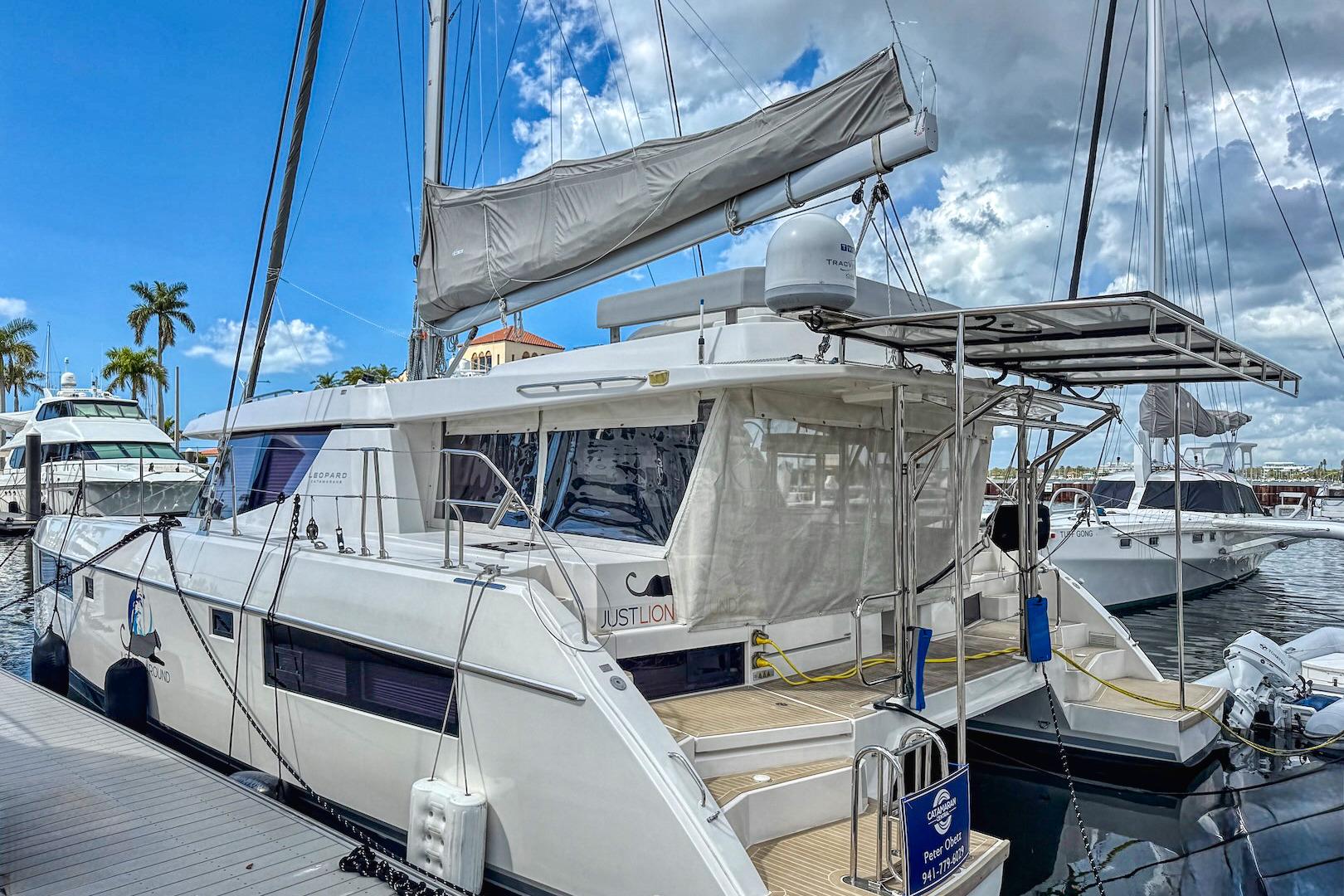 2020 Leopard 45 catamaran docked at marina under blue sky.