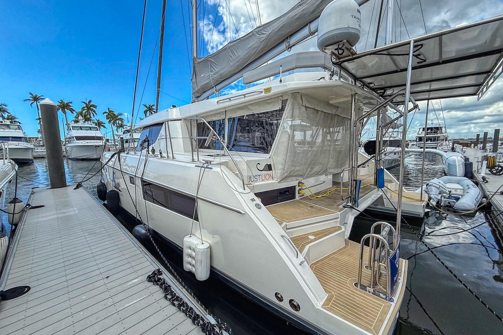 2020 Leopard 45 catamaran docked at marina, featuring sleek design and spacious deck.