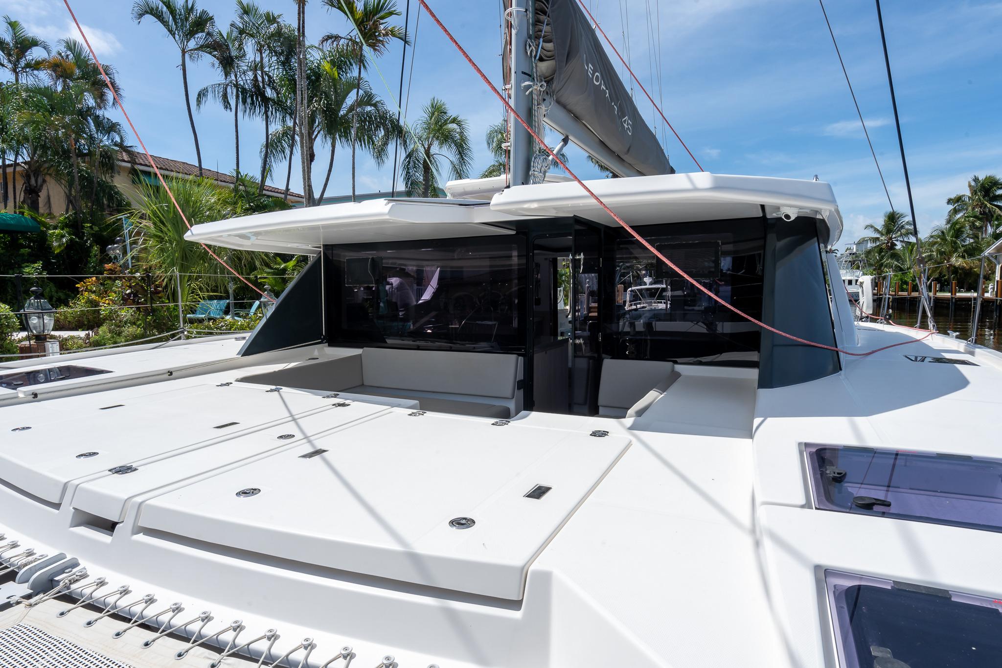 2020 Leopard 45 catamaran with spacious deck, surrounded by tropical palm trees.