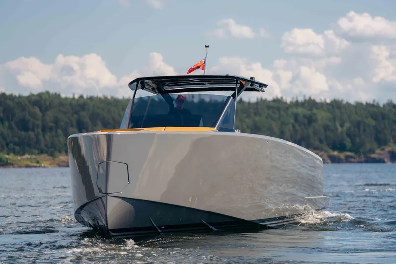  Yacht Photos Pics 2024 Pardo Yachts P43 cruising on a serene lake with forested shoreline.