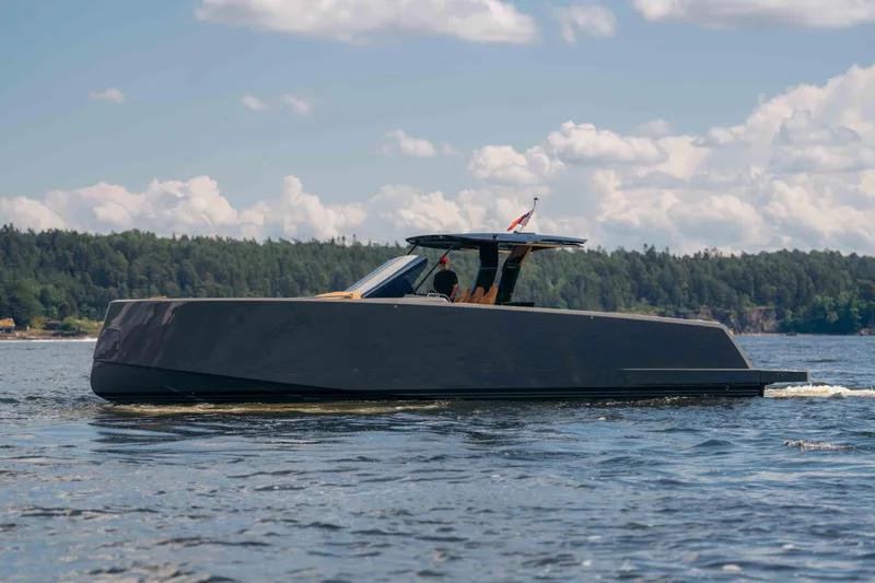  Yacht Photos Pics 2024 Pardo Yachts P43 cruising on a scenic lake under a partly cloudy sky.