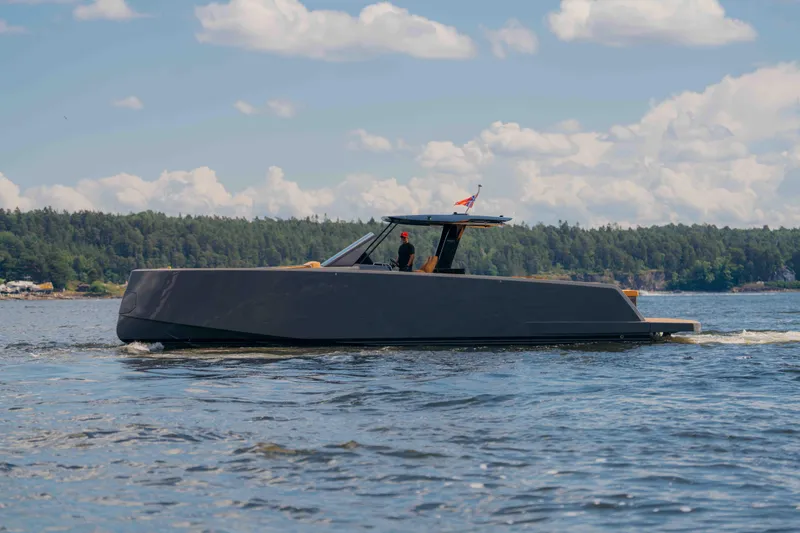  Yacht Photos Pics 2024 Pardo Yachts P43 cruising on a scenic lake under a partly cloudy sky.