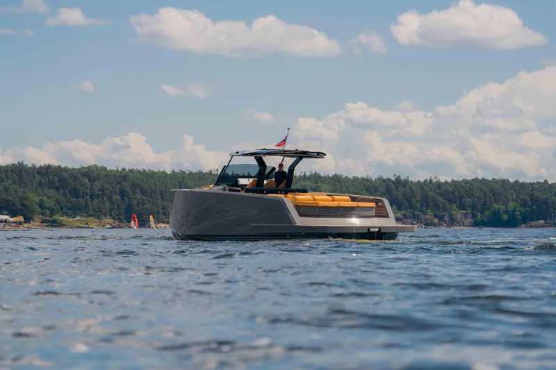  Yacht Photos Pics 2024 Pardo Yachts P43 cruising on a scenic lake under a partly cloudy sky.