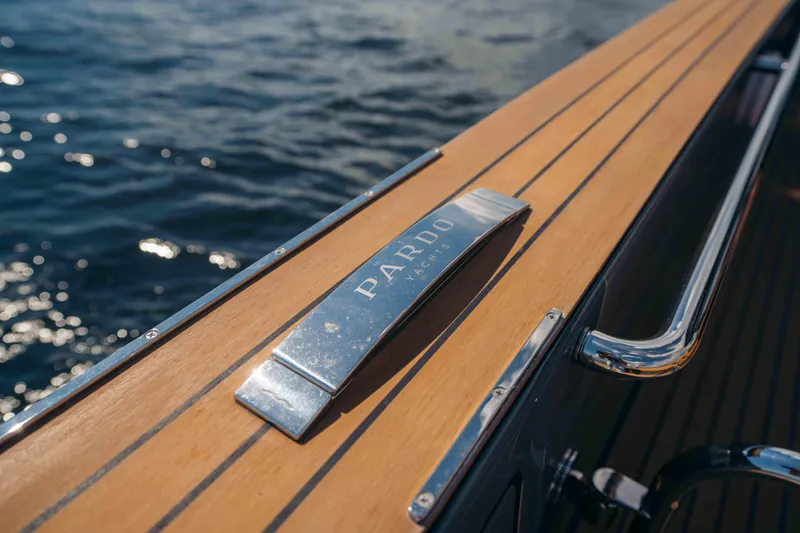  Yacht Photos Pics 2024 Pardo Yachts P43 deck detail with logo, featuring sleek wood finish by the water.