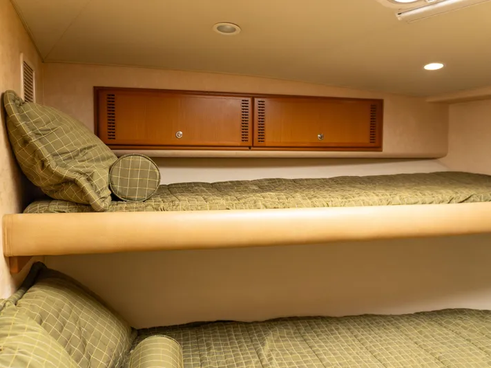 Miss Shell Yacht Photos Pics Interior cabin of 2008 Cabo 38 Express with bunk beds and storage cabinets.