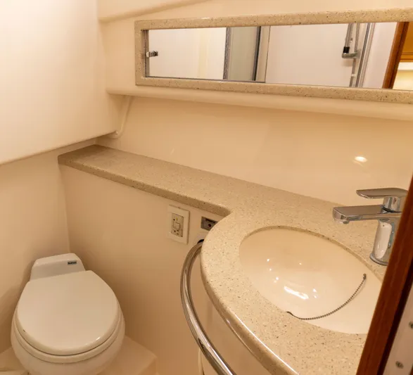 Miss Shell Yacht Photos Pics Bathroom interior of a 2008 Cabo 38 Express yacht with sink, toilet, and mirror.