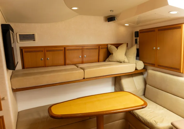 Miss Shell Yacht Photos Pics Interior of 2008 Cabo 38 Express with cozy seating and wooden cabinetry.