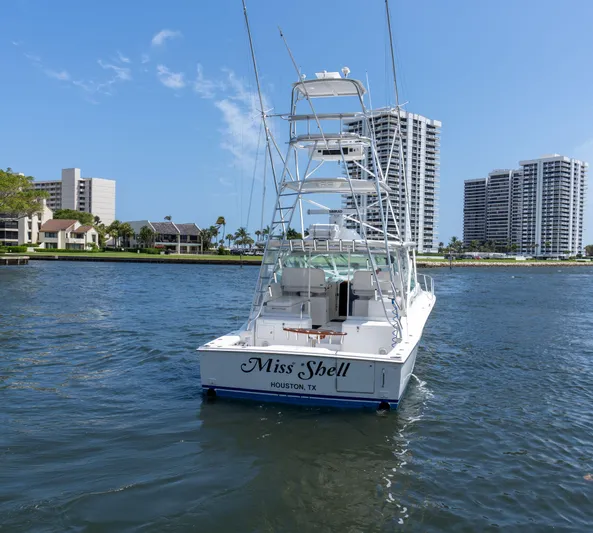 Miss Shell Yacht Photos Pics 2008 Cabo 38 Express boat Miss Shell on water near high-rise buildings.