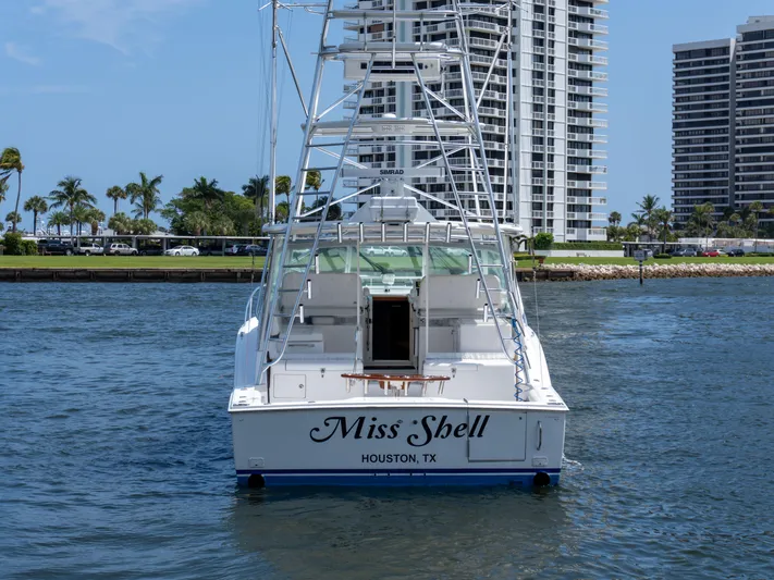 Miss Shell Yacht Photos Pics 2008 Cabo 38 Express boat named Miss Shell in Houston, TX, docked near high-rise buildings.