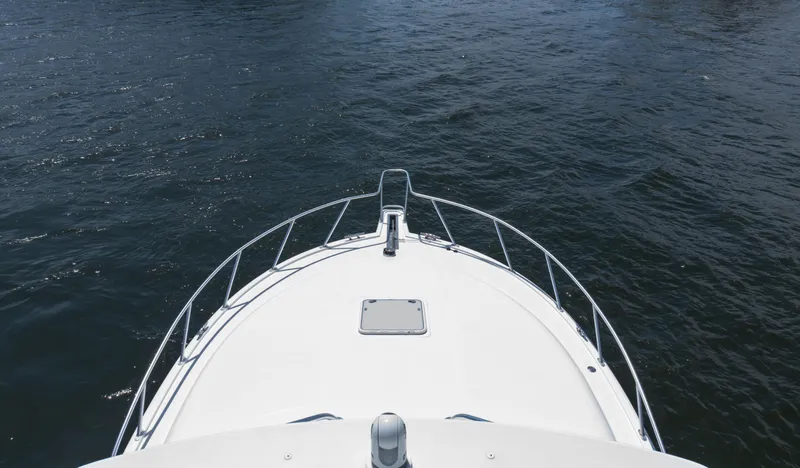 Miss Shell Yacht Photos Pics Bow view of 2008 Cabo 38 Express boat on water.