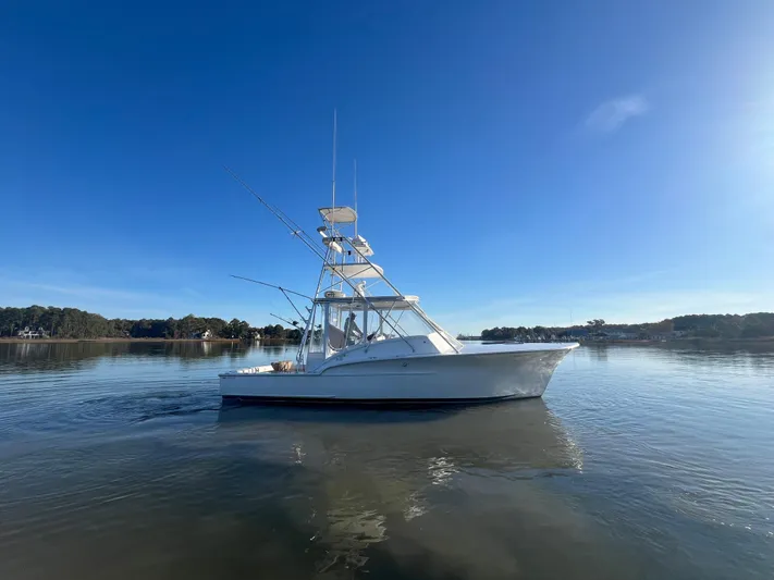 Precedent Yacht Photos Pics 1998 Jersey Cape 36 Express boat on calm water under clear blue sky.