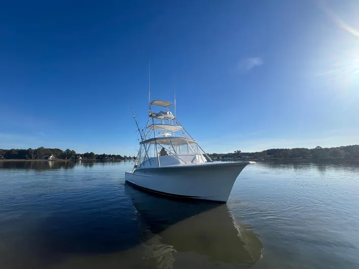 Precedent Yacht Photos Pics 1998 Jersey Cape 36 Express boat on calm water under clear blue sky.