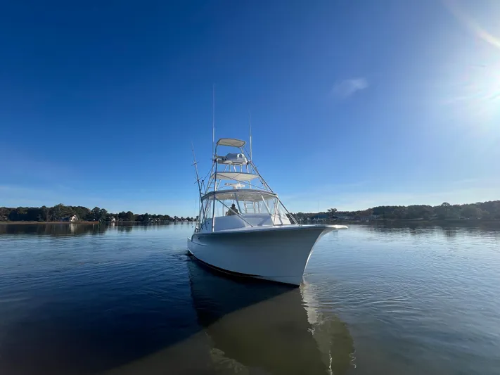 Precedent Yacht Photos Pics 1998 Jersey Cape 36 Express boat on calm water under clear blue sky.