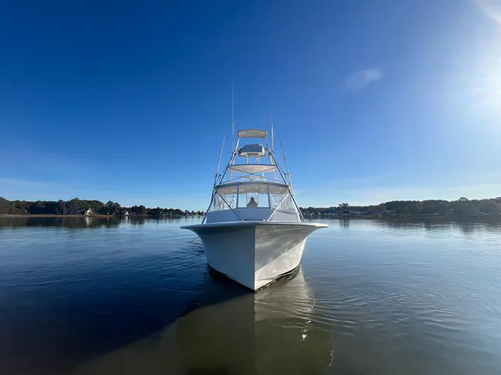 Precedent Yacht Photos Pics 1998 Jersey Cape 36 Express boat on calm water under clear blue sky.