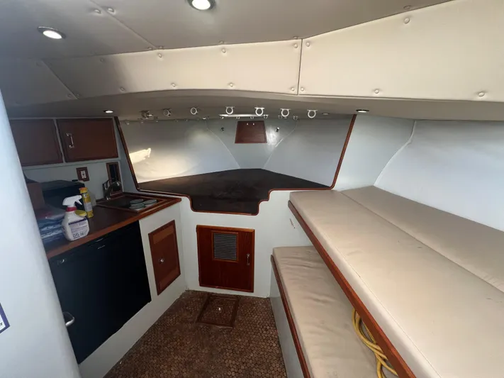 Precedent Yacht Photos Pics Interior of 1998 Jersey Cape 36 Express boat with cozy seating and kitchenette.