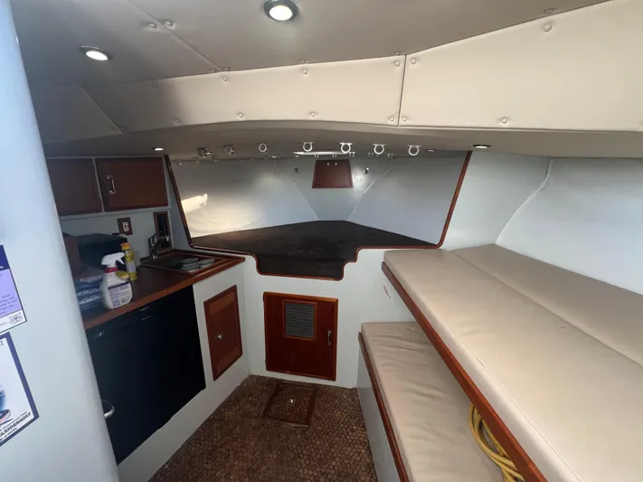 Precedent Yacht Photos Pics Interior of 1998 Jersey Cape 36 Express boat with kitchenette and seating area.