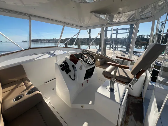 Precedent Yacht Photos Pics Interior view of 1998 Jersey Cape 36 Express boat cockpit with steering wheel and seating.