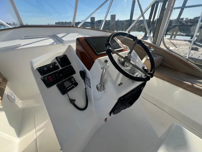 Precedent Yacht Photos Pics Helm of 1998 Jersey Cape 36 Express boat with steering wheel and control panel.