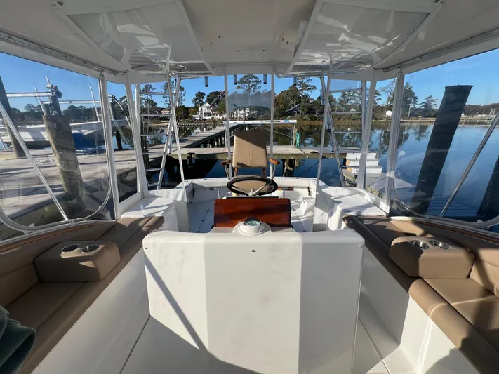 Precedent Yacht Photos Pics 1998 Jersey Cape 36 Express boat interior with helm, seating, and marina view.