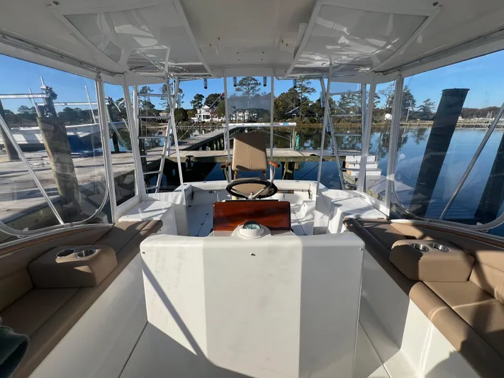 Precedent Yacht Photos Pics 1998 Jersey Cape 36 Express boat interior with helm, seating, and marina view.