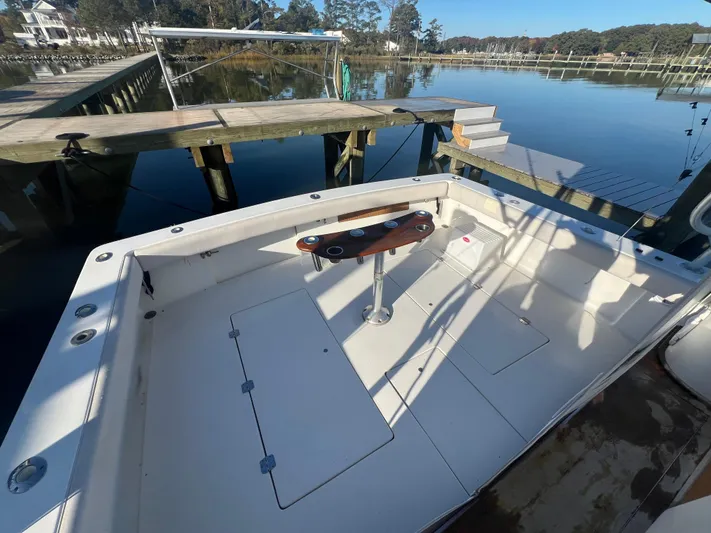Precedent Yacht Photos Pics 1998 Jersey Cape 36 Express boat docked, featuring spacious deck and fishing rod holders.