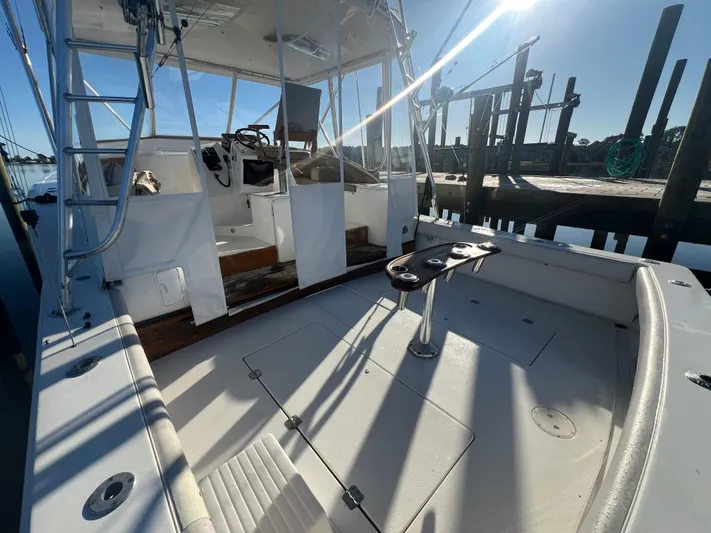 Precedent Yacht Photos Pics 1998 Jersey Cape 36 Express boat docked, showcasing spacious deck and helm area.