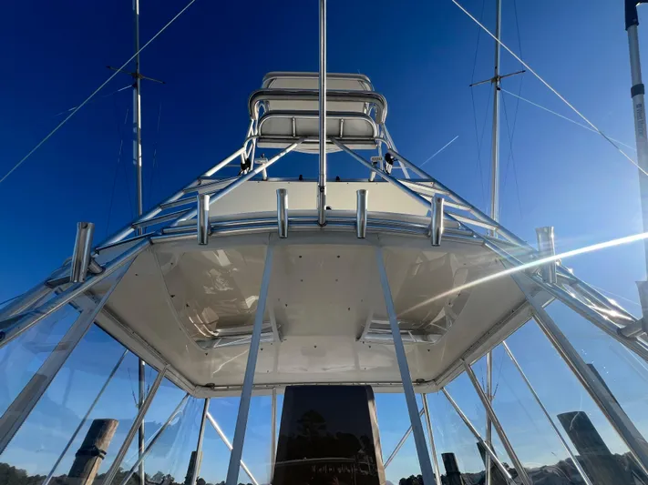 Precedent Yacht Photos Pics 1998 Jersey Cape 36 Express boat, viewed from below, against a clear blue sky.
