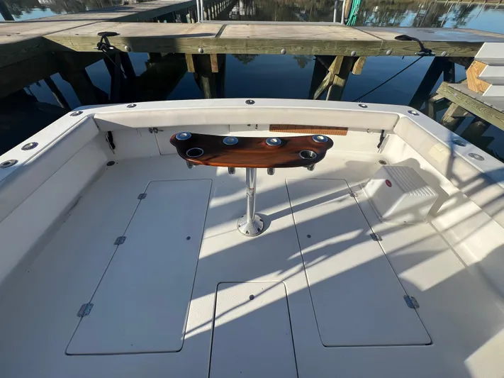 Precedent Yacht Photos Pics 1998 Jersey Cape 36 Express boat deck with rod holders, docked by wooden pier.