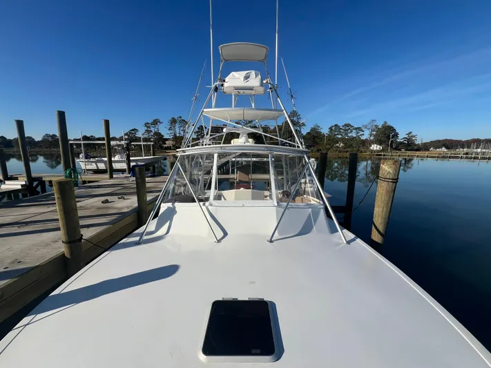 Precedent Yacht Photos Pics 1998 Jersey Cape 36 Express boat docked on calm water under clear blue sky.