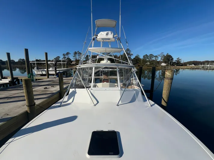 Precedent Yacht Photos Pics 1998 Jersey Cape 36 Express boat docked on a calm, sunny day.