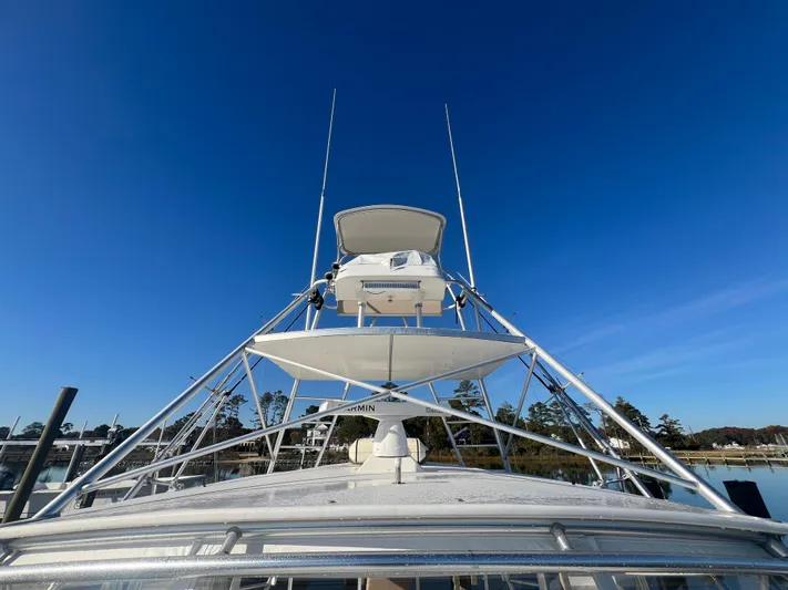 Precedent Yacht Photos Pics 1998 Jersey Cape 36 Express boat with tower against clear blue sky.