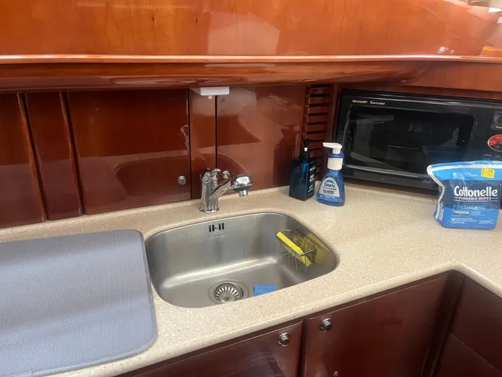 C Glass Yacht Photos Pics Kitchen area of a 2000 Princess 65 M/Y yacht with sink and microwave.