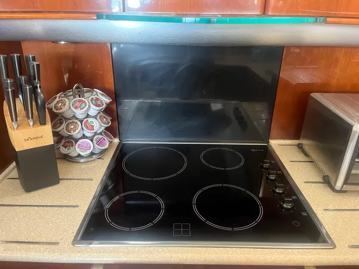 C Glass Yacht Photos Pics Modern yacht kitchen with electric stove, knife set, and coffee pods, Princess 65 M/Y, 2000.