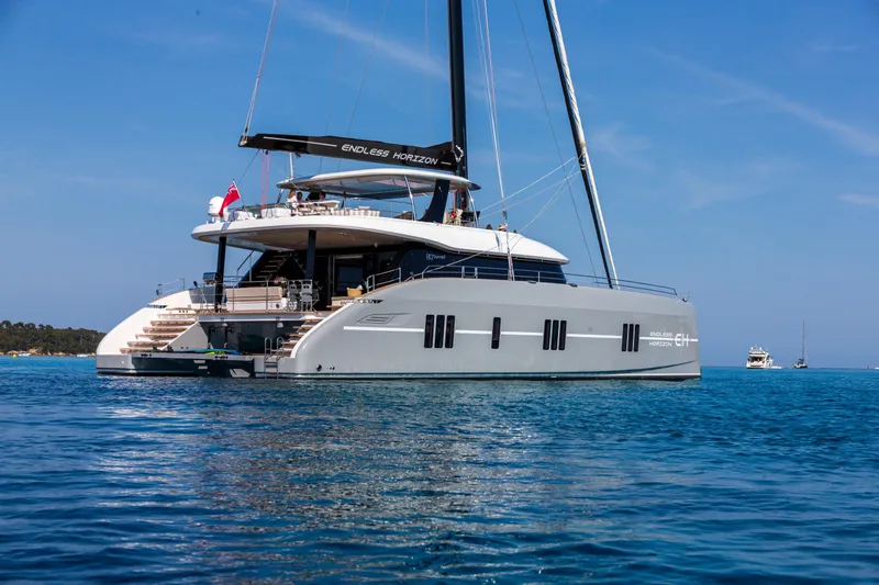 Endless Horizon II Yacht Photos Pics 2022 Sunreef 80 Sail catamaran on calm blue water, showcasing luxury and elegance.