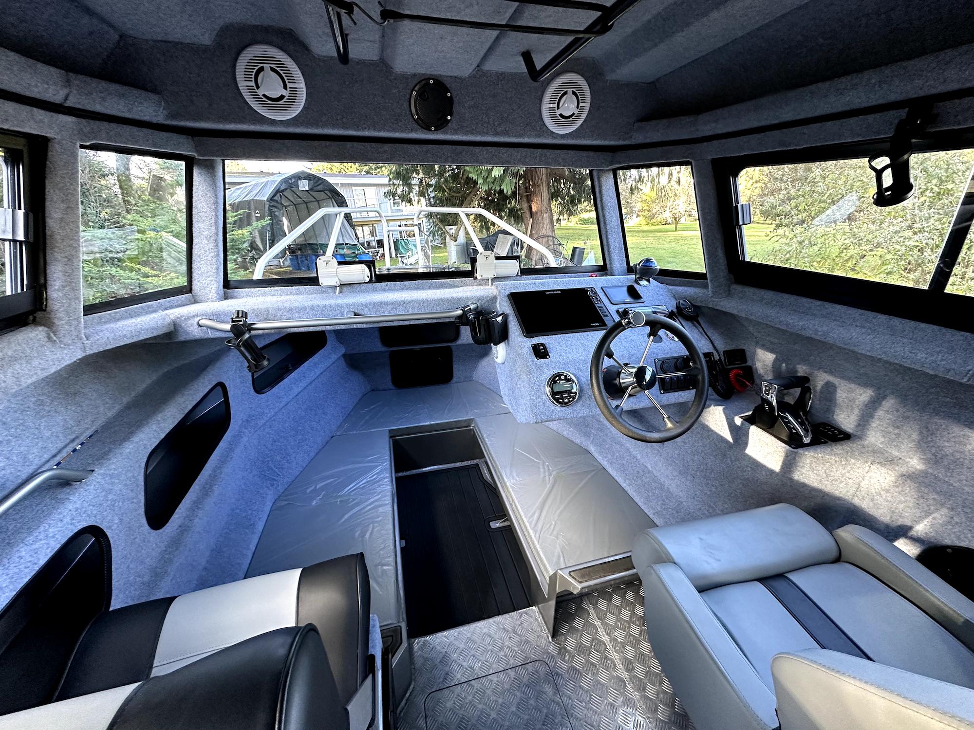Interior of 2023 Custom Ocean King boat, featuring modern dashboard and seating.
