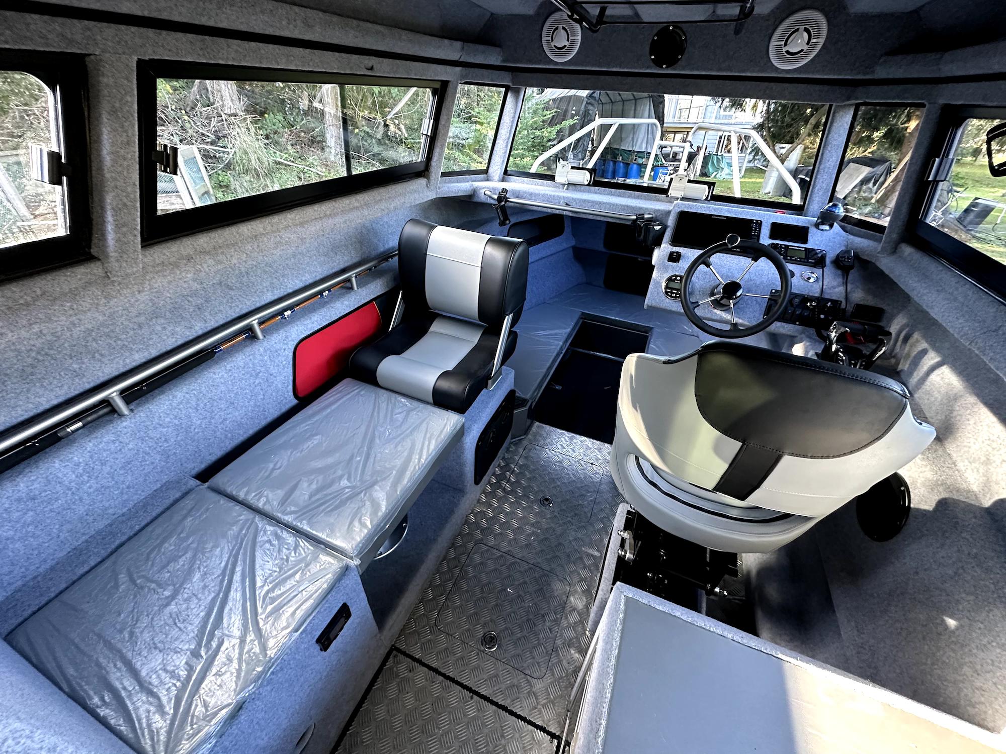 Interior of 2023 Custom Ocean King boat with modern seating and control panel.