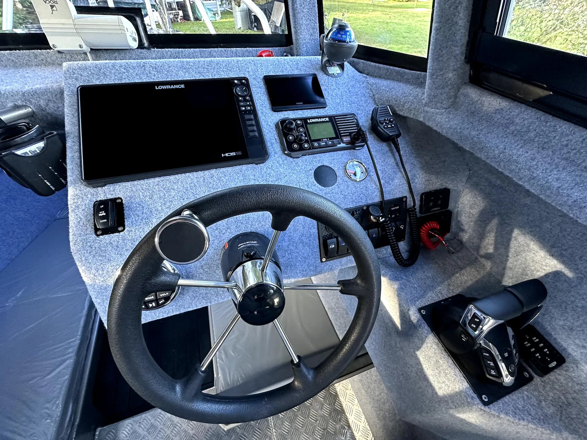 2023 Custom Ocean King boat dashboard with steering wheel, navigation, and communication controls.