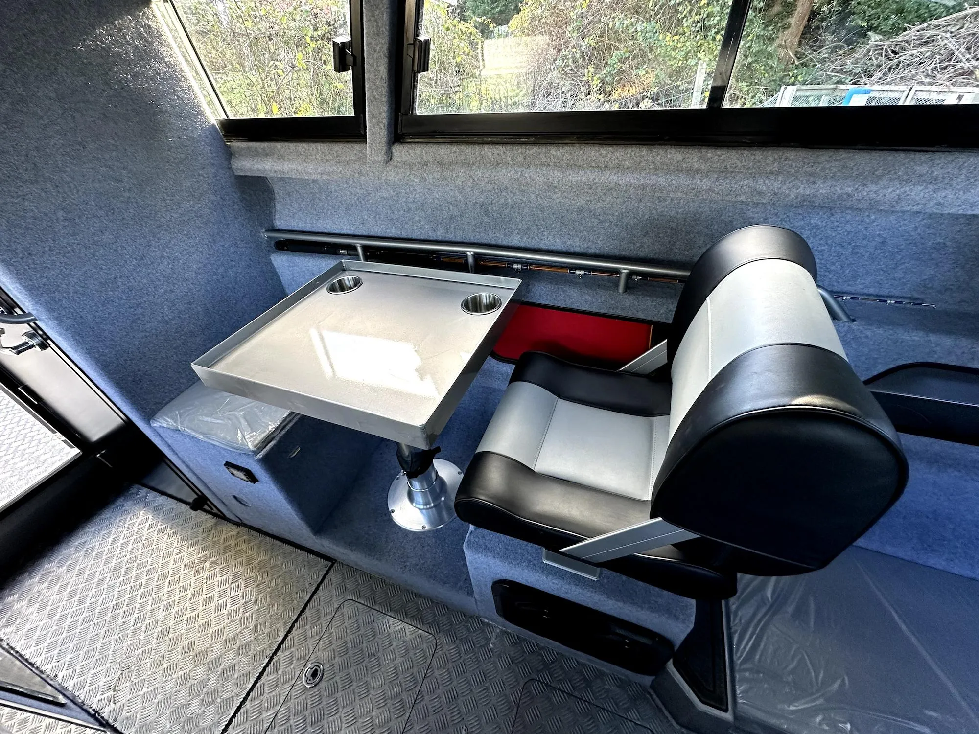 Interior of 2023 Custom Ocean King boat with seating and table setup.