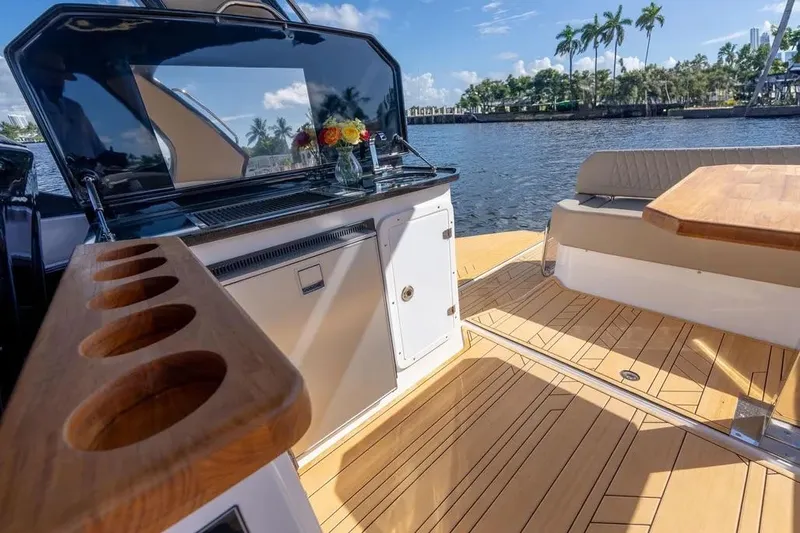 Yacht Photos Pics Luxurious Hanover 347 yacht interior with wooden deck, seating, and water view, 2025 model.